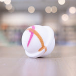 Pink orange design on white circle bath bomb