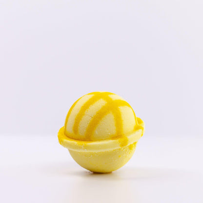 Light yellow Bath Bomb with dark yellow design against white background