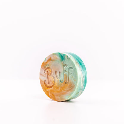 angled left view of teal, white, and orange Narcissist Shave Bar with "Buff" engraved in bar