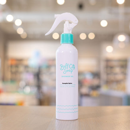 Pumpkin Spice Shower Oil spray bottle with teal finishes on wooden counter